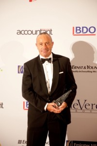 TRIUMPH: Ian Schneider, a senior Partner at PwC poses with the award after the firm won the ‘Corporate Finance Deal of the Year’ gong at the ICAEW awards event. 